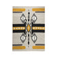 A rectangular area rug with an intricate geometric pattern in earthy tones. The design features bold black, white, and yellow shapes, including diamonds and zigzags, arranged symmetrically across the surface. The rug adds a striking visual element, perfect for enhancing a contemporary or rustic decor style.