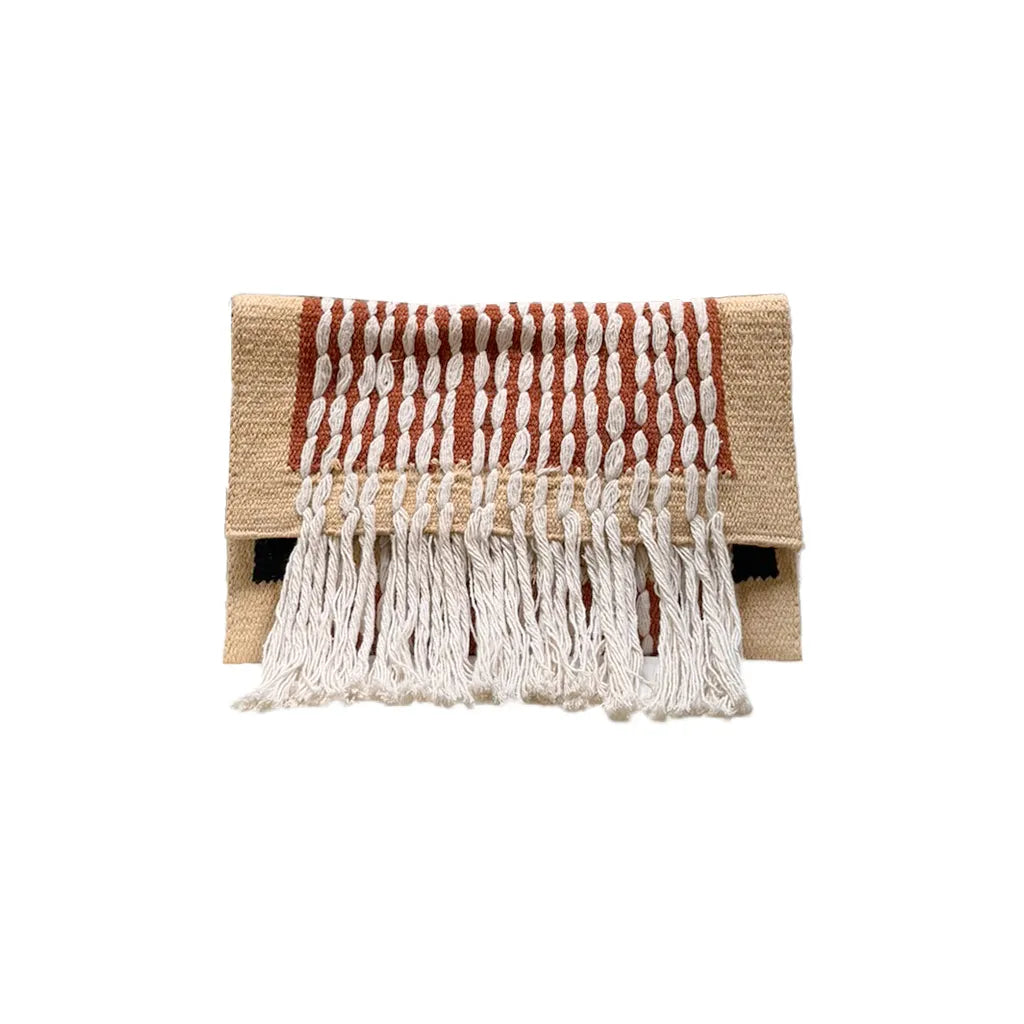 A woven clutch bag featuring a beige base with red and white vertical stripes and fringed detailing at the bottom.