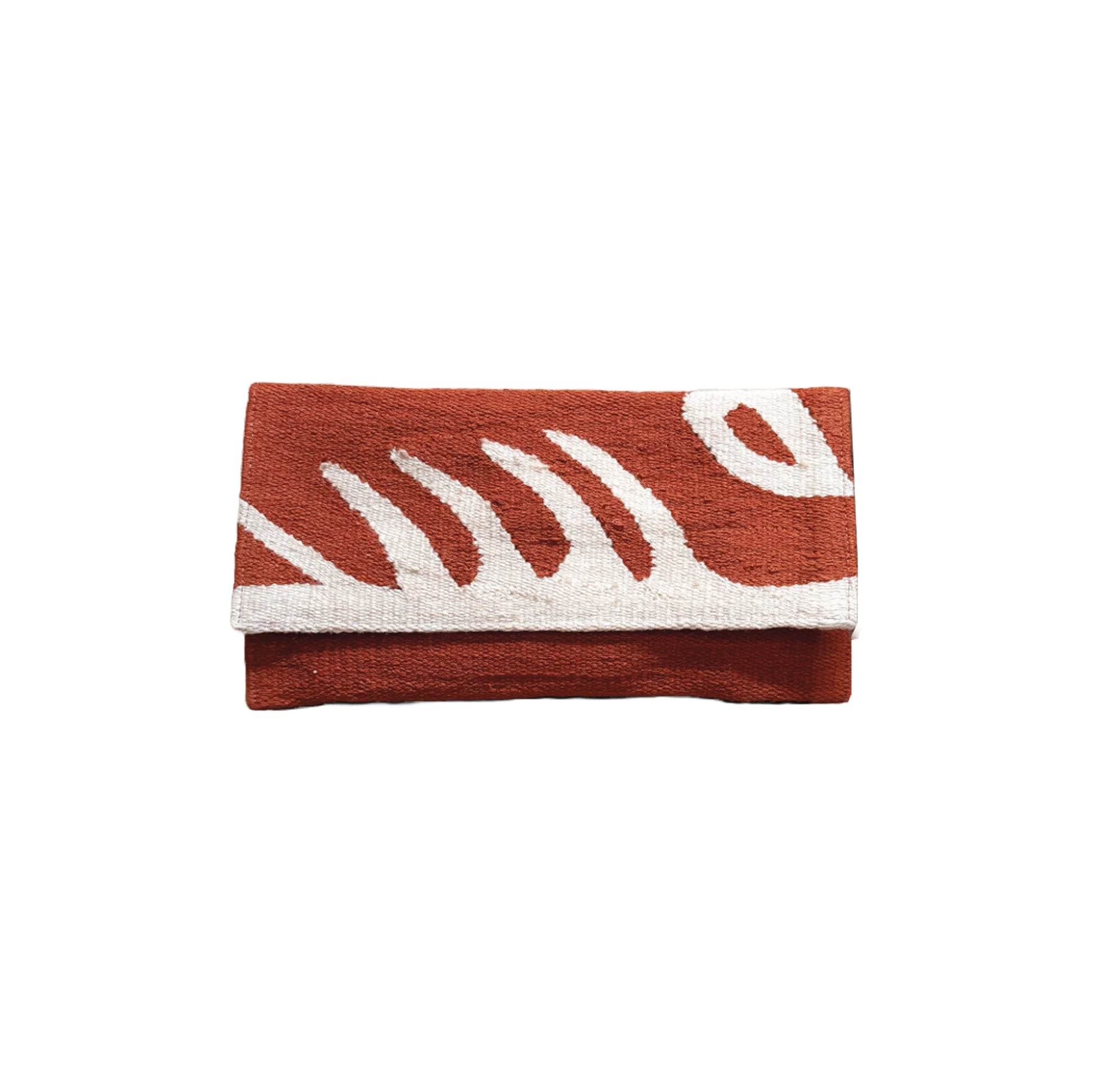 "A flat woven clutch in terracotta with bold abstract white leaf patterns. The clutch is neatly folded, showcasing its textured fabric and modern design."