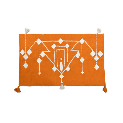 This 1 x 1.5 meter rug features a bold, orange background and a striking white geometric pattern that consists of interconnected diamond shapes, creating a visually engaging composition. The edges are adorned with fringed tassels made of the same material, contributing to the traditional and artisanal aesthetic.