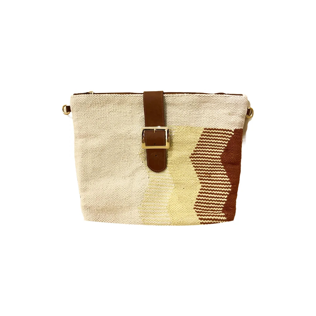 "A stylish, multicolored woven handbag featuring a blend of beige, yellow, and rust patterns with a distinctive zigzag design. The bag has a top zipper closure and a leather strap with a buckle detail, showcasing a modern and artistic flair."