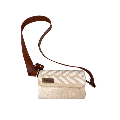 "A cream-colored woven bag with a textured white chevron pattern, featuring a brown leather strap. The bag is displayed against a white background, highlighting its elegant design."