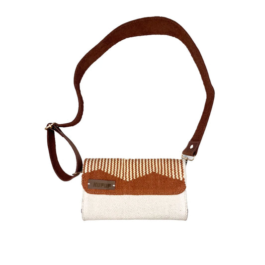 A woven handbag is displayed against a white background. The bag features a terracotta and cream design with a brown leather strap. A small brand tag is visible, emphasizing its stylish and functional design.